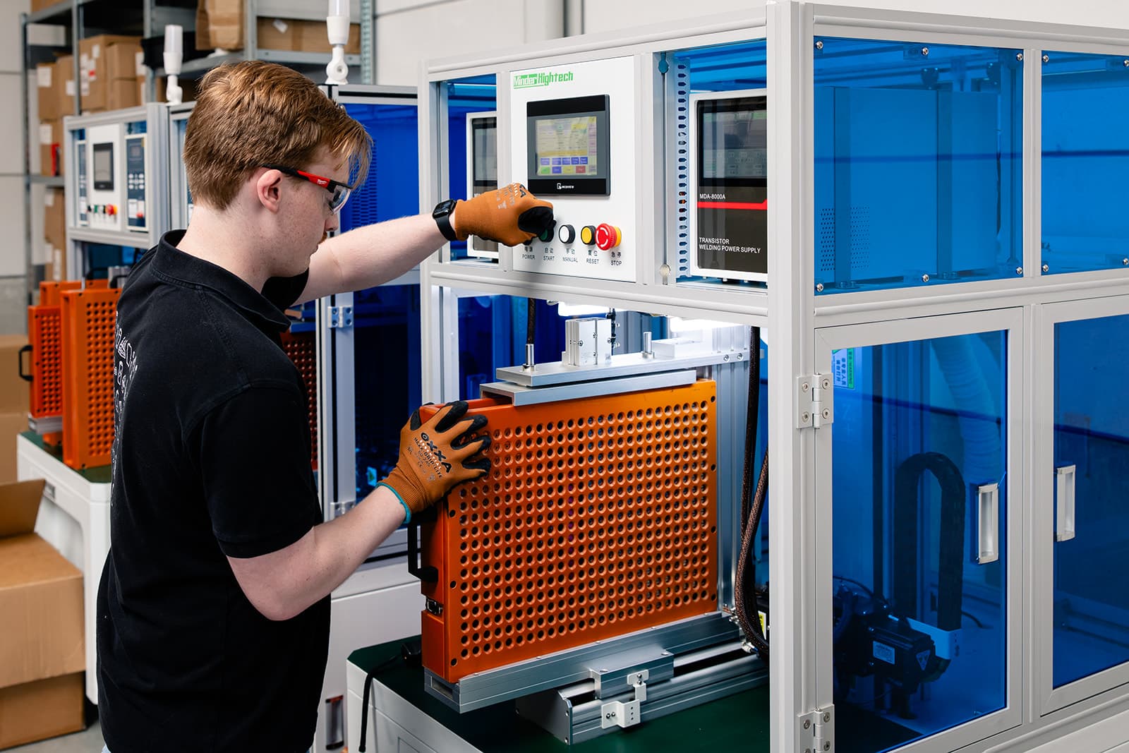 Ampacon employee placing battery pack into machine